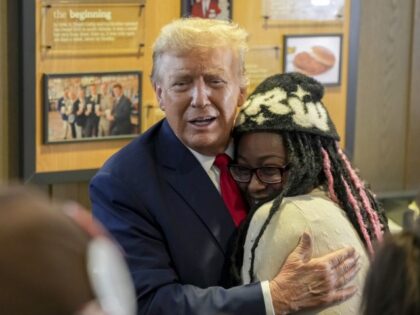 Republican presidential candidate former President Donald Trump, left, hugs a customer as