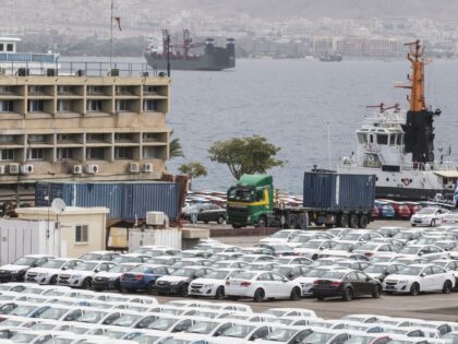 Military police escorts a truck carrying a container to a nearby navy base on March 9, 201