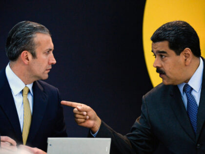 Venezuela's President Nicolas Maduro (R) speaks with Vice-President Tarek El Aissami