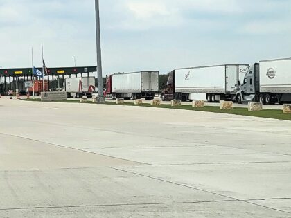 Tractor-trailers await inspection at the Falfurias Border Patrol Checkpoint in Brooks Coun