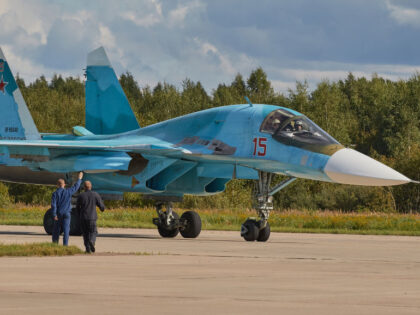 KUBINKA, RUSSIA - 2020/08/29: A group of technicians meets the Su-34 on the runway. Aviati