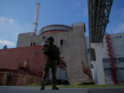 A Russian serviceman stands guard the territory outside the second reactor of the Zaporizh
