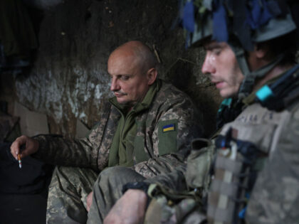 TOPSHOT - Ukrainian soldiers have a break in a trench on the front line with Russian troop