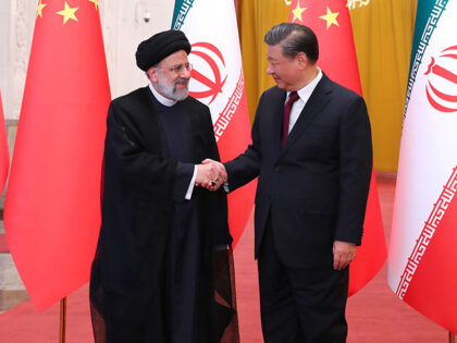Iranian President Ebrahim Raisi (L) being welcomed by Chinese President Xi Jinping (R) wit