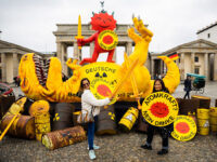 15 April 2023, Berlin: Tourists from the Philippines pose with swords and shields in front