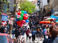 People shop as daily life continues with warm days of spring arriving at Ulus district of