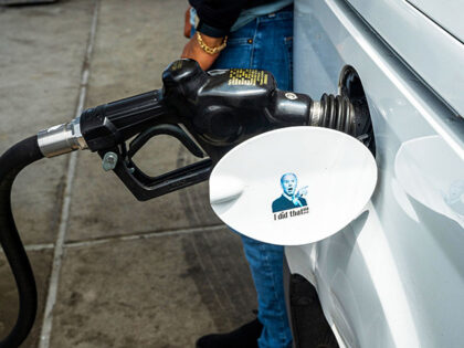 A sticker of US President Joe Biden as a customer refuels at a Chevron gas station in San