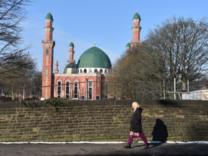 BRADFORD, ENGLAND - FEBRUARY 12: A lady walks past Al-Jamia Suffa-Tul-Islam Grand Mosque o