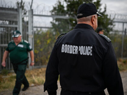 Bulgarian border police officers patrol near the wall fence on the Bulgaria-Turkey border