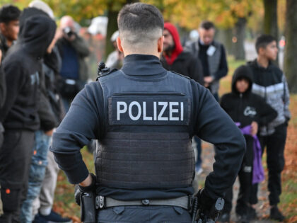 11 October 2023, Brandenburg, Forst: Illegal migrants are guarded by an officer of the Fed