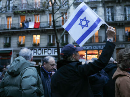 A woman waves a flag of Israel during a march against anti-Semitism in Paris on November 1