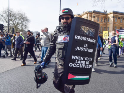 LONDON, UNITED KINGDOM - 2024/03/09: A protester wearing a wartime press uniform holds a s