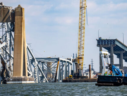 A crane, the first of several needed, is positioned by the wreckage of the Francis Scott K
