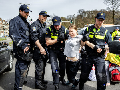 TOPSHOT - Swedish climate activist Greta Thunberg (C) is arrested during a climate march a