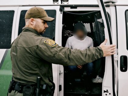 US Border Patrol agents prepare to transport migrants for asylum claim processing at the U