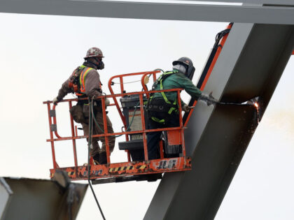 BALTIMORE, MARYLAND - APRIL 04: Workers cut pieces of the Francis Scott Key Bridge after i