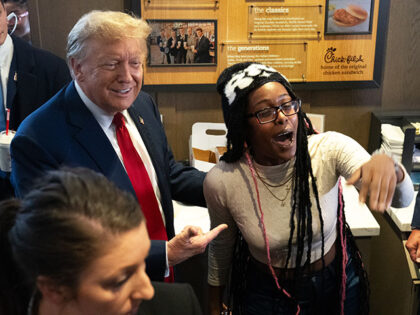 Former U.S. President Donald Trump meets with people during a visit to a Chick-fil-A resta