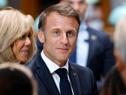 France's President Emmanuel Macron and his wife Brigitte Macron (L) arrive for a Nati