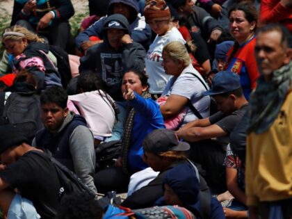 CIUDAD JUAREZ, MEXICO - APRIL 17: Migrants wait for American security forces to let them e