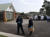 Police forensics officers work at the compound of a church where a stabbing attack occurre