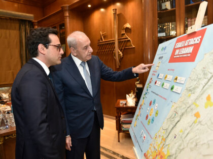 Lebanon's Parliament Speaker Nabih Berri (R) speaks with France's Minister for Foreign and