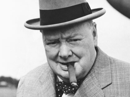 British statesman Winston Churchill in 1949, smoking one of his beloved cigars as he leave
