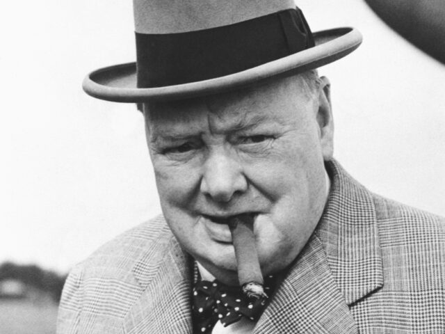British statesman Winston Churchill in 1949, smoking one of his beloved cigars as he leave