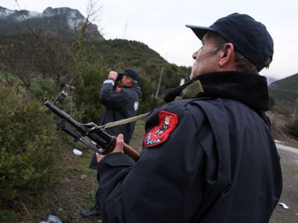 Albanian police officers patrol at the Albanian-Greek border in Carshove near the city of