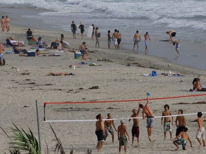 Beach goers enjoy acitiviites in the surf at the beach in Cardiff-by-the Sea, CA on Saturd
