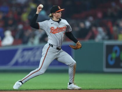 Jackson Holliday #7 of the Baltimore Orioles throws to first during the eighth inning agai
