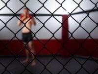 Caucasian cage fighter standing in cage