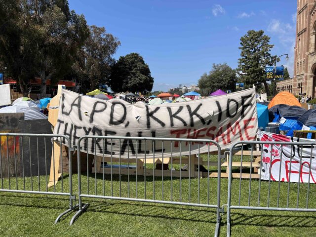 An anti-Israel and anti-police banner hangs on an illegal barricade at UCLA called the &qu