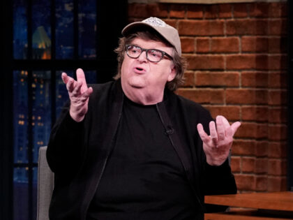 LATE NIGHT WITH SETH MEYERS -- Episode 863 -- Pictured: (l-r) Filmmaker Michael Moore duri