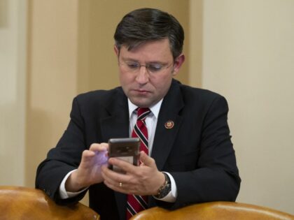 Rep. Mike Johnson (R-LA) looks at a phone during a break of the House Judiciary Committee