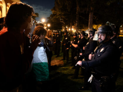 Los Angeles police officers stand a line with students protesting against the Israel-Pales