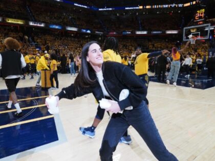 INDIANAPOLIS, IN - APRIL 26: Caitlin Clark #22 of the Indiana Fever throws out t-shirts d