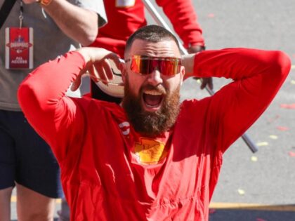 KANSAS CITY, MO - FEBRUARY 14: Travis Kelce yells and raises his hands to fire up the crow