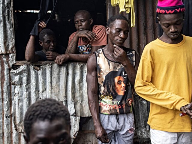 People gather in a Kush drug den in Freetown on June 26, 2023. In recent years Kush, a mix