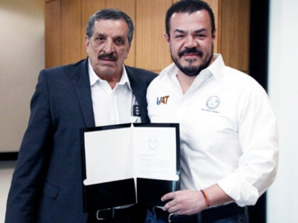 Marco Antonio Batarse (left) receives his title as Administration Secretary for the Autono
