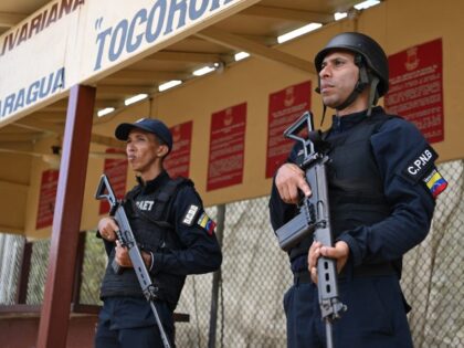 Members of the Bolivarian National Police stand guard in the Tocoron prison in Tocoron, Ar
