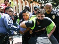 LOS ANGELES, CALIFORNIA - APRIL 24: USC public safety officers detain a pro-Palestine demo