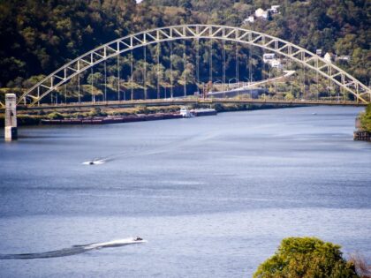 Pleasure boats move along the surface of the Ohio River near the West End Bridge, Wednesda