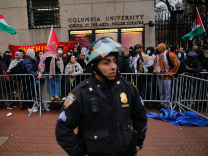 An NYPD officer stand guard as pro-Palestinian protesters gather outside of Columbia Unive