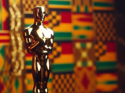 Oscars statue in front of a kente cloth.