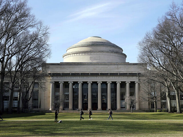 FILE - Students walk past the 