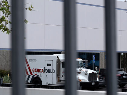 Armored trucks are parked outside the GardaWorld facility in the Sylmar section of Los Ang