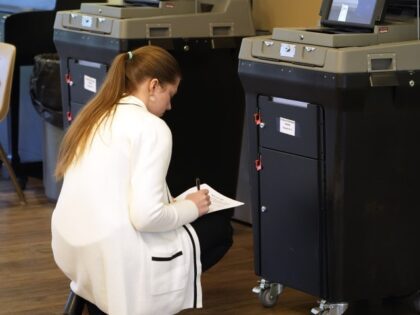A Mississippi Republican Party poll worker documents the security on the electronic ballot