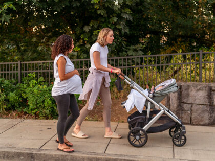 Young Mothers Walking Together Outdoors - stock photo