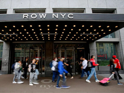 People make their way past The Row NYC Hotel at Times Square on October 13, 2022 in New Yo