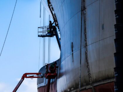 Welders seam together part of a Hull of a ship being constructed in the General Dynamics N